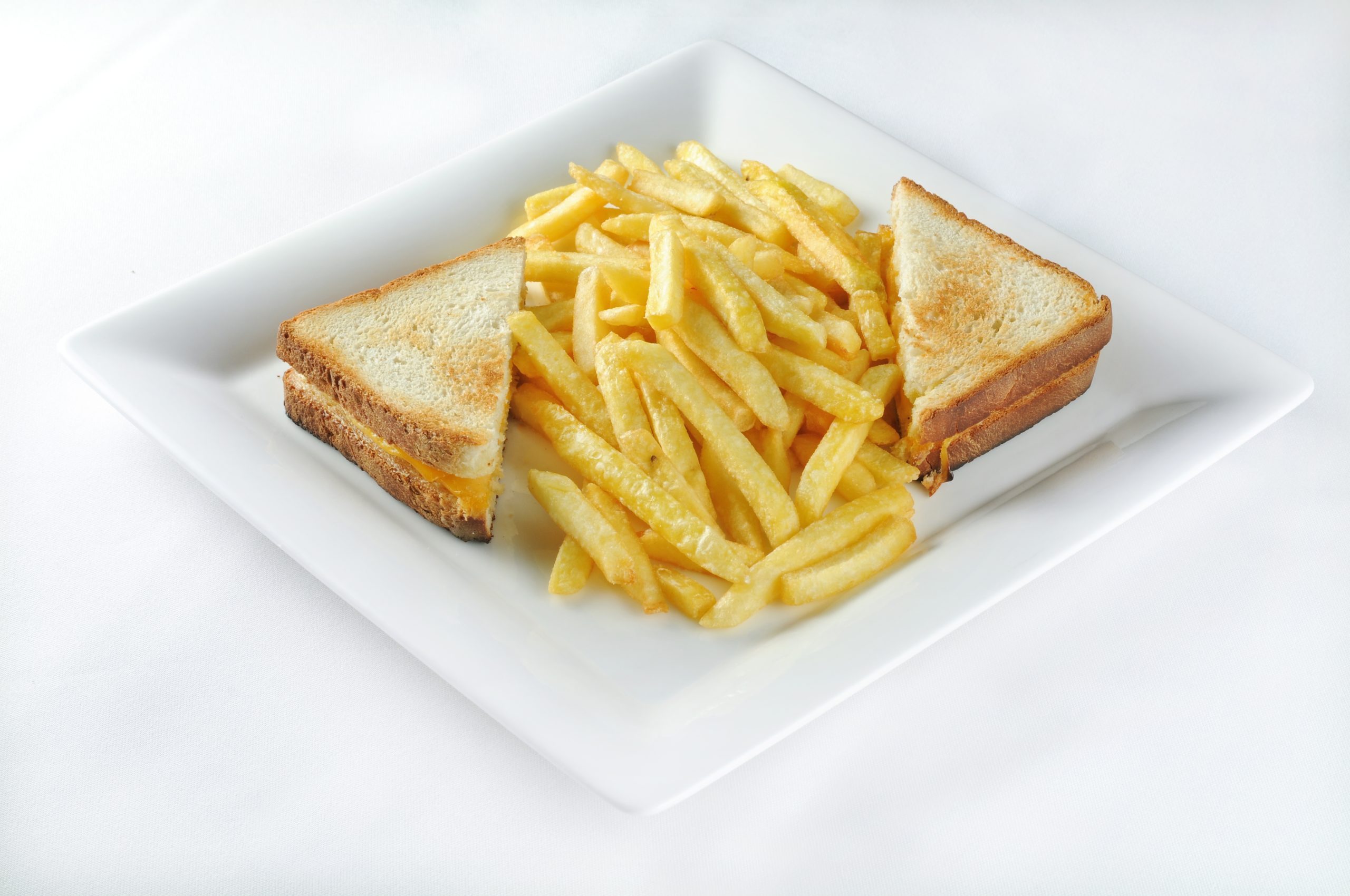 Isolated shot of Croque monsieur with french fries - perfect for a food blog or menu usage